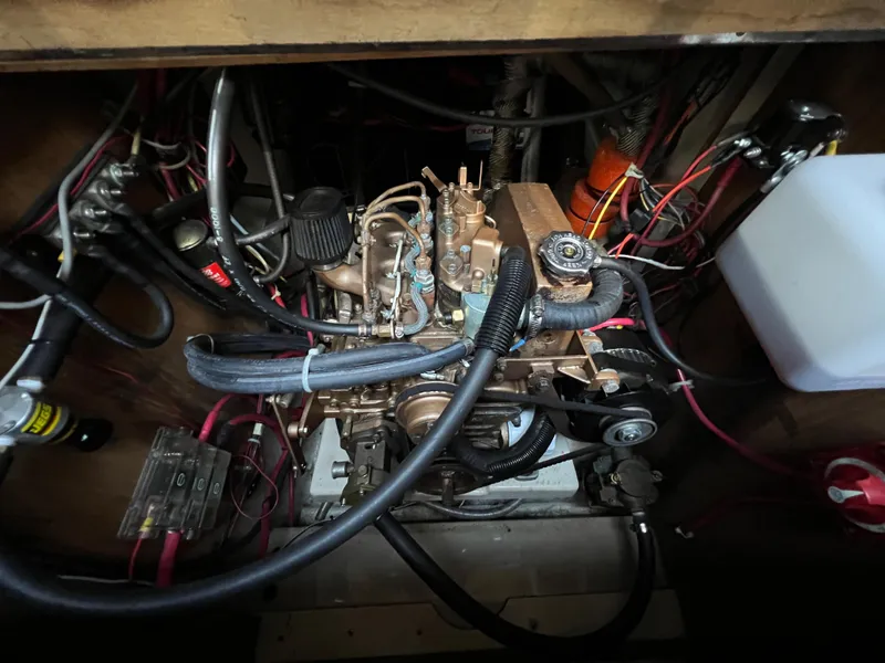 Slide: The Image of Engine compartment of a 1983 O'Day 34 sailboat, showing wiring and components. - 35