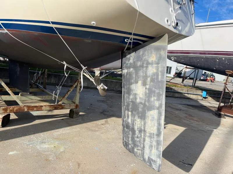 Slide: The Image of 1983 O'Day 34 sailboat on dry dock, showing keel and hull details. - 40