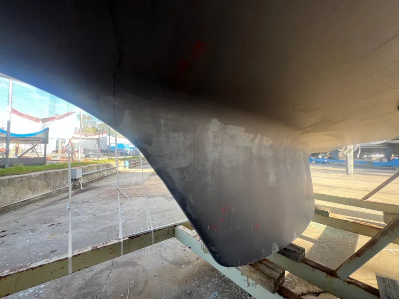 Slide: The Image of 1983 O'Day 34 sailboat keel in dry dock, showing hull details and support structure. - 44