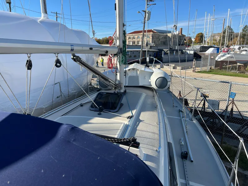 Slide: The Image of 1983 O'Day 34 sailboat docked in a marina, surrounded by other boats. - 9