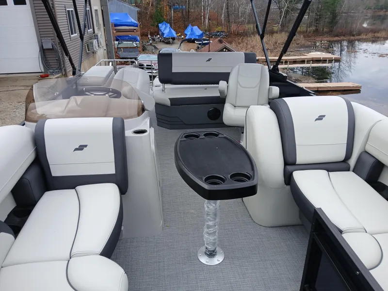 Slide: The Image of 2025 Starcraft EXS 1 Q DH pontoon boat interior with plush seating and table. - 4