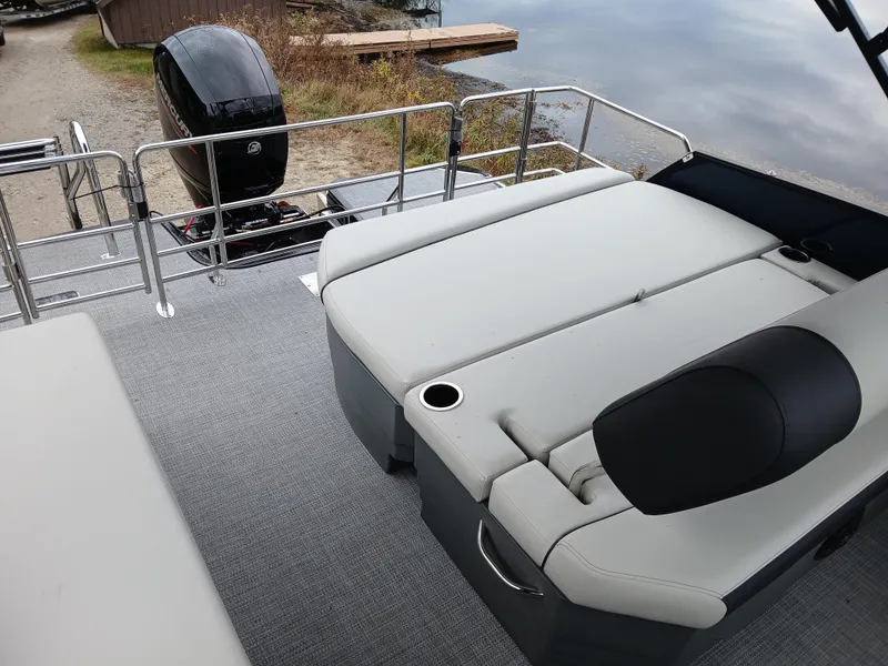 Slide: The Image of 2025 Starcraft EXS 1 Q DH boat with cushioned seating and outboard motor. - 5
