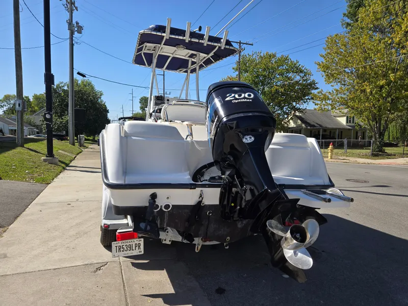 Slide: The Image of 2004 Boston Whaler 210 Outrage boat with 200 OptiMax engine on a street. - 10