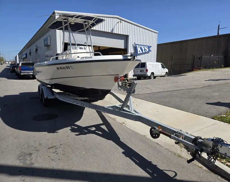 Slide: The Image of 2004 Boston Whaler 210 Outrage on trailer outside industrial building. - 4