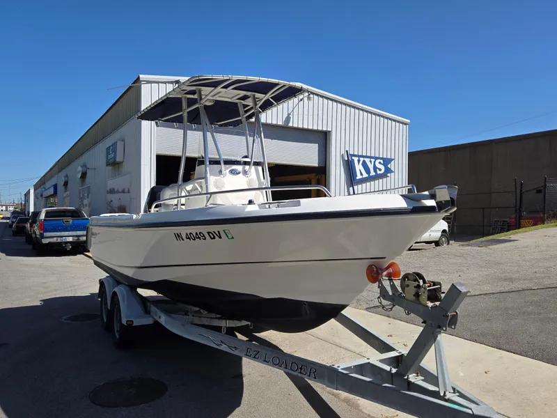 Slide: The Image of 2004 Boston Whaler 210 Outrage on trailer outside a warehouse. - 7