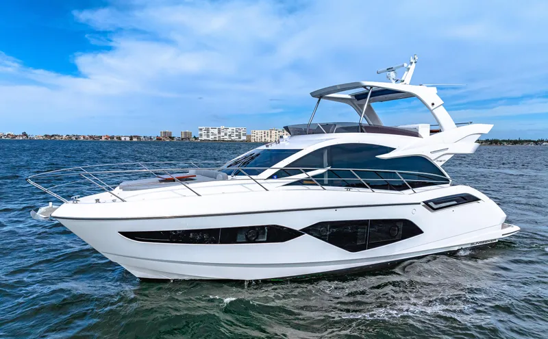 Slide: The Image of 2021 Sunseeker Manhattan 55 yacht cruising on open water. - 1