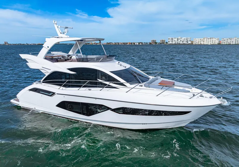 Slide: The Image of 2021 Sunseeker Manhattan 55 yacht cruising on open water. - 12