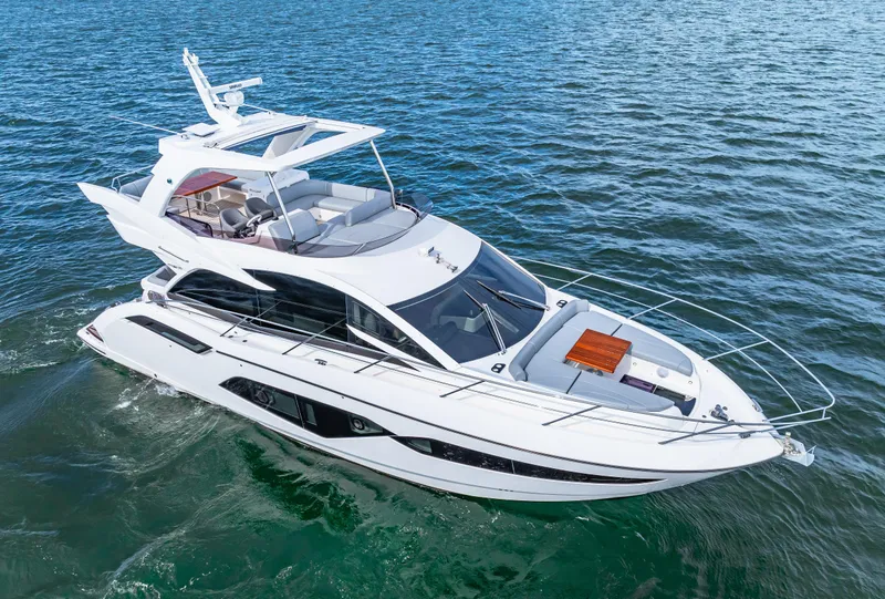 Slide: The Image of 2021 Sunseeker Manhattan 55 yacht cruising on open water. - 13