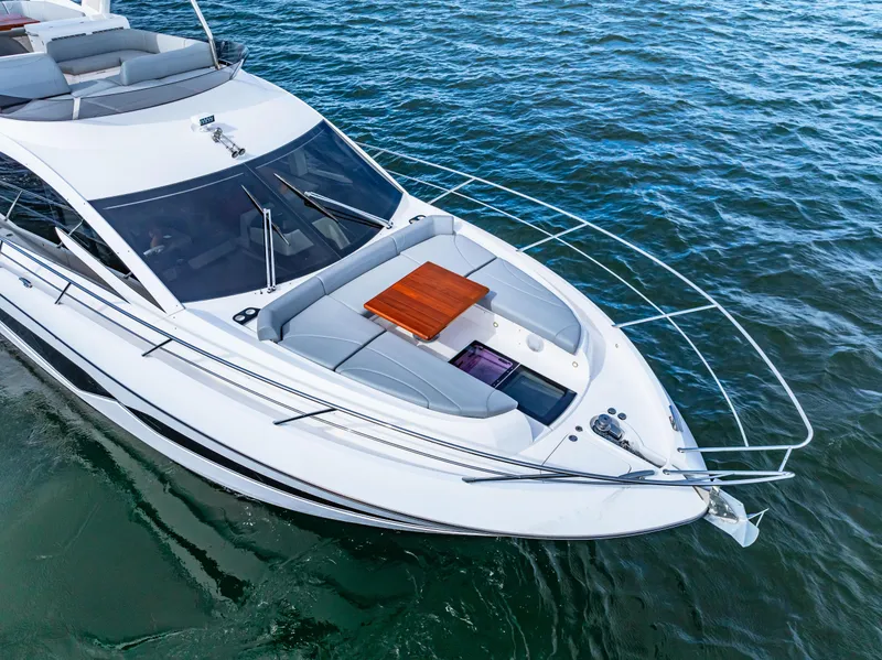 Slide: The Image of Sunseeker Manhattan 55 yacht, 2021 model, cruising on clear blue water. - 15