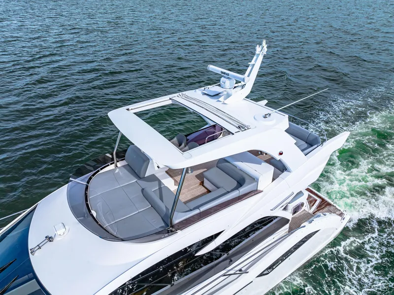 Slide: The Image of Sunseeker Manhattan 55 yacht cruising on open water, 2021 model. - 17
