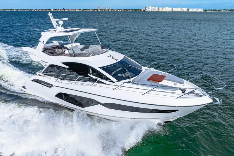 Slide: The Image of 2021 Sunseeker Manhattan 55 yacht cruising on open water. - 19