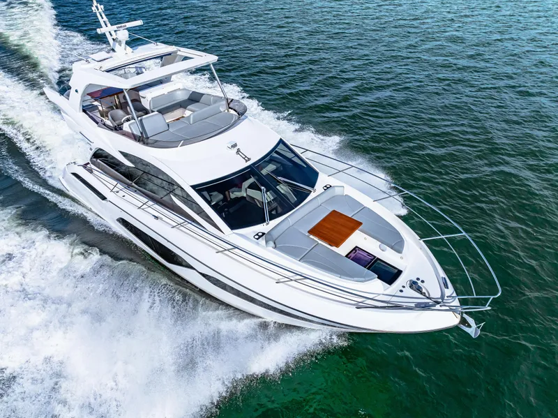 Slide: The Image of 2021 Sunseeker Manhattan 55 yacht cruising on open water. - 20