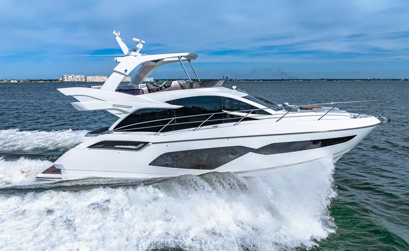 Slide: The Image of 2021 Sunseeker Manhattan 55 yacht cruising on open water. - 24