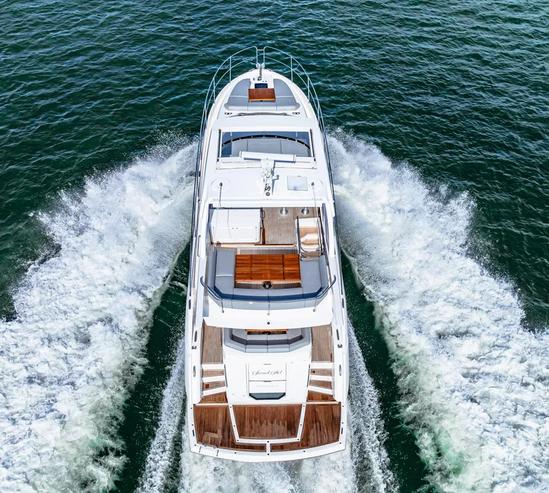 Slide: The Image of 2021 Sunseeker Manhattan 55 yacht cruising on open water, aerial view. - 25