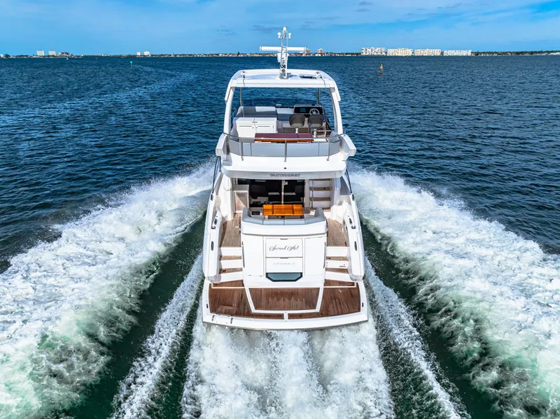 Slide: The Image of Sunseeker Manhattan 55 yacht cruising on open water, rear view, 2021 model. - 26