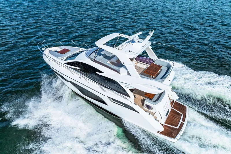 Slide: The Image of 2021 Sunseeker Manhattan 55 yacht cruising on open water. - 27