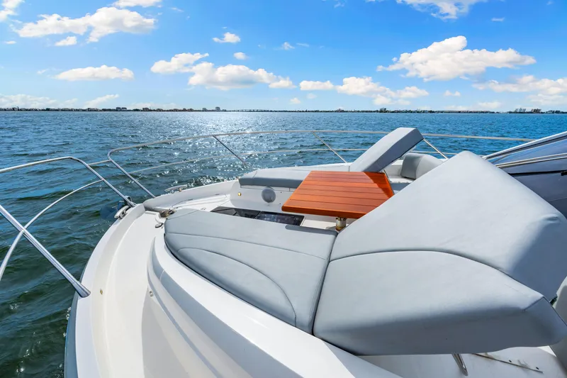 Slide: The Image of Sunseeker Manhattan 55 yacht deck with sun loungers, 2021 model, on open water. - 36