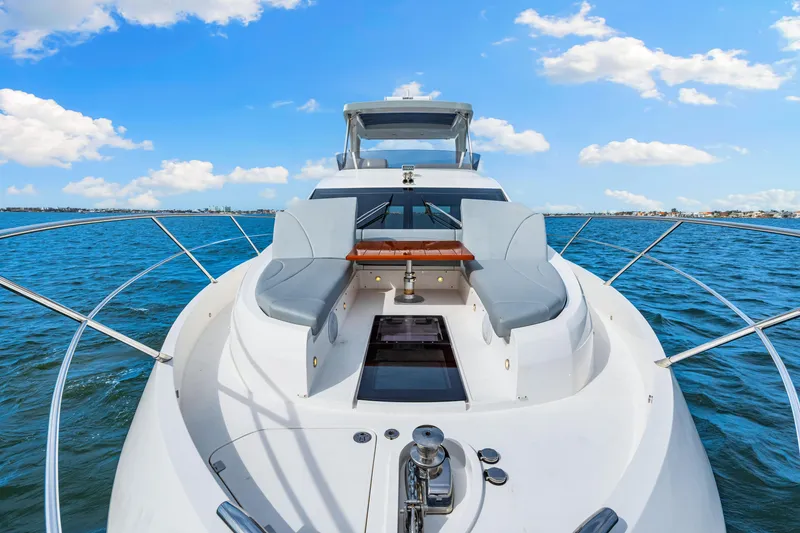 Slide: The Image of Sunseeker Manhattan 55 yacht, 2021 model, cruising on open water under a clear blue sky. - 37
