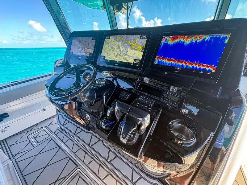 Slide: The Image of 2020 HCB 53 Sueños helm with advanced navigation and control systems, overlooking turquoise waters. - 22