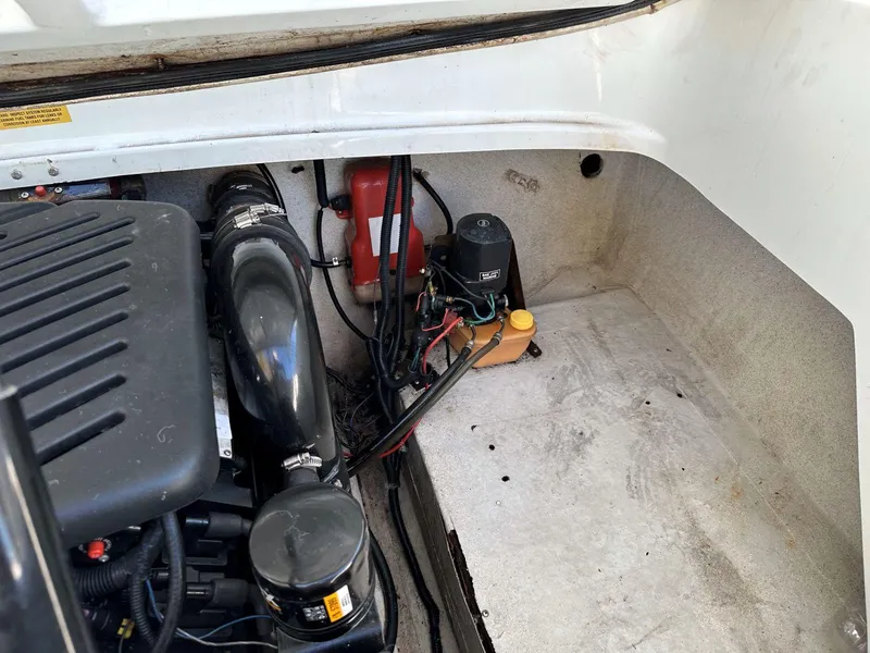 Slide: The Image of Engine compartment of a 1995 Baja 272 Islander boat, showing mechanical components. - 13