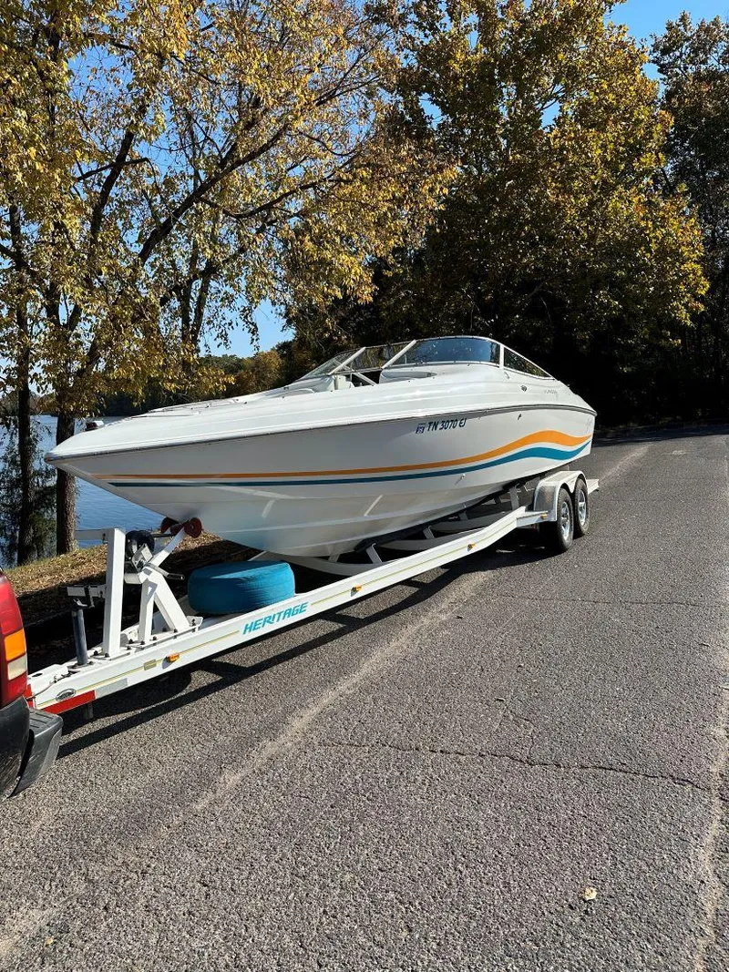Slide: The Image of 1995 Baja 272 Islander boat on trailer, parked on a road with autumn trees. - 2