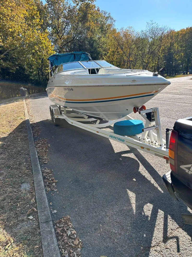 Slide: The Image of 1995 Baja 272 Islander boat on trailer in sunny parking lot. - 6