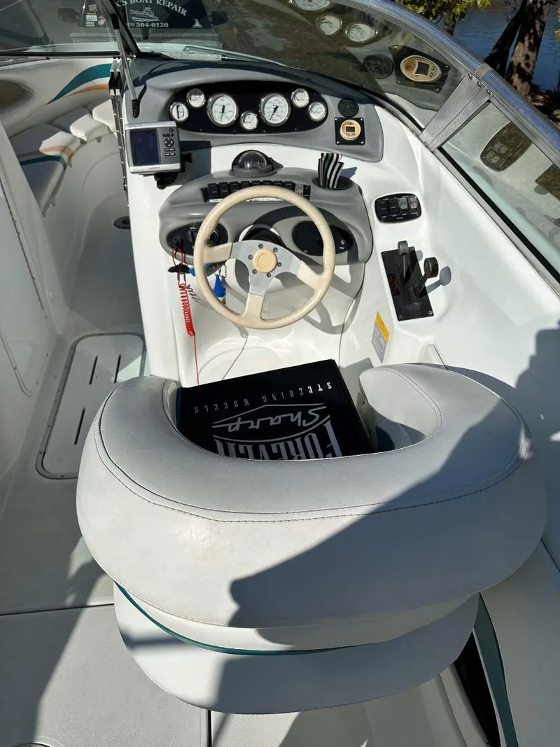 Slide: The Image of 1995 Baja 272 Islander boat cockpit with steering wheel and instrument panel. - 8