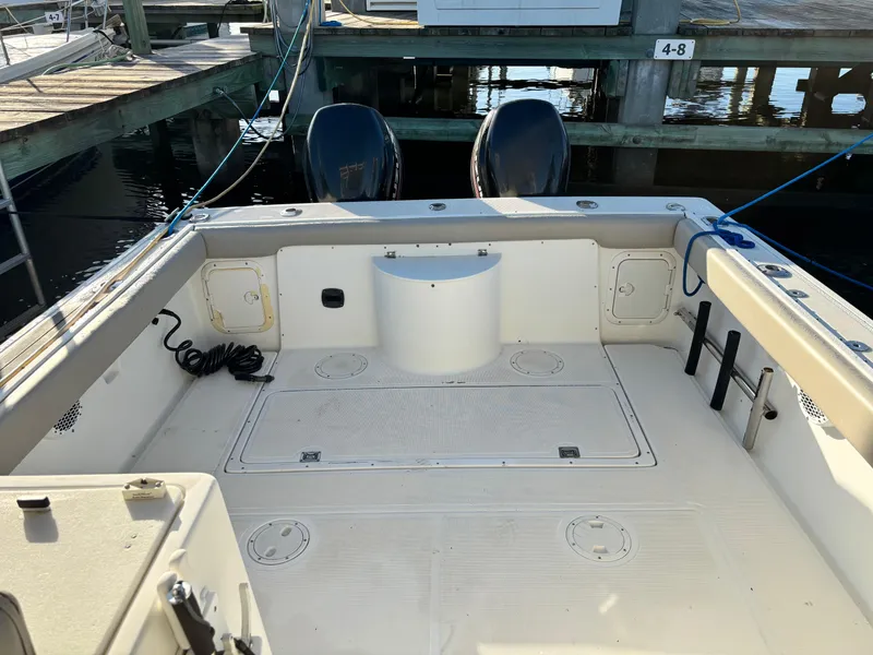 Slide: The Image of 1992 Pursuit 2800 Open boat interior with dual engines at dock. - 4