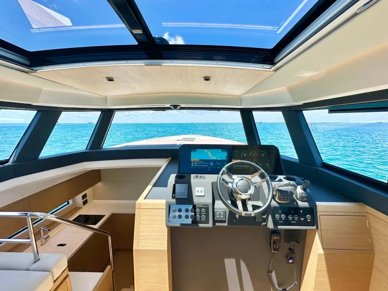 Slide: The Image of Interior of 2023 Pardo Yachts GT52, featuring modern helm and panoramic ocean view. - 17