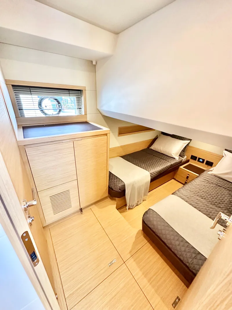 Slide: The Image of 2023 Pardo Yachts GT52 cabin with twin beds, modern design, and natural wood finishes. - 31