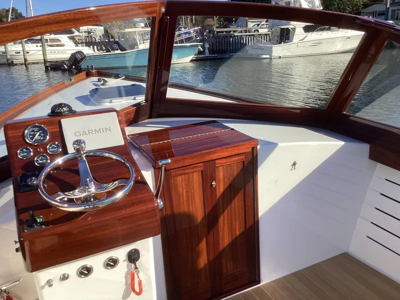 Slide: The Image of 2024 MacKenzie Cuttyhunk boat helm with Garmin navigation, docked in marina. - 12