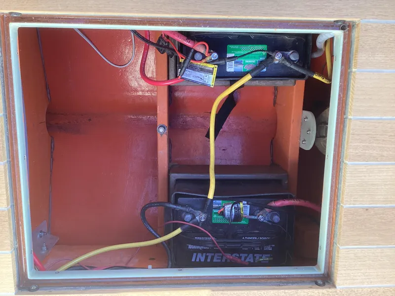 Slide: The Image of Battery compartment of 2024 MacKenzie Cuttyhunk boat with wiring and connections. - 25
