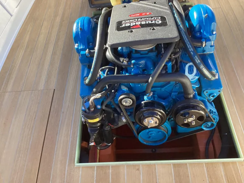 Slide: The Image of 2024 MacKenzie Cuttyhunk boat engine, blue, on wooden deck. - 27