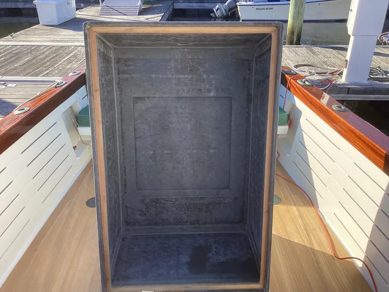 Slide: The Image of 2024 MacKenzie Cuttyhunk boat interior with open storage compartment. - 30