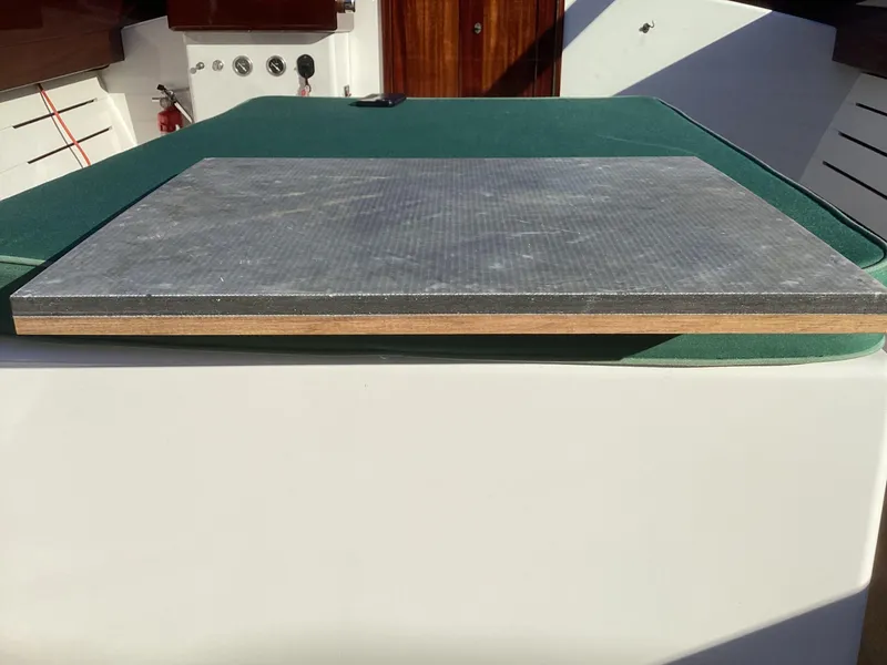 Slide: The Image of 2024 MacKenzie Cuttyhunk boat deck with green and gray surfaces. - 31