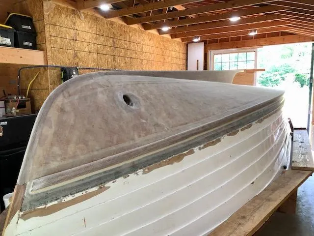 Slide: The Image of 2024 MacKenzie Cuttyhunk boat under construction in a wooden workshop. - 37