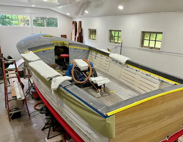 Slide: The Image of 2024 MacKenzie Cuttyhunk boat under restoration in a workshop. - 40
