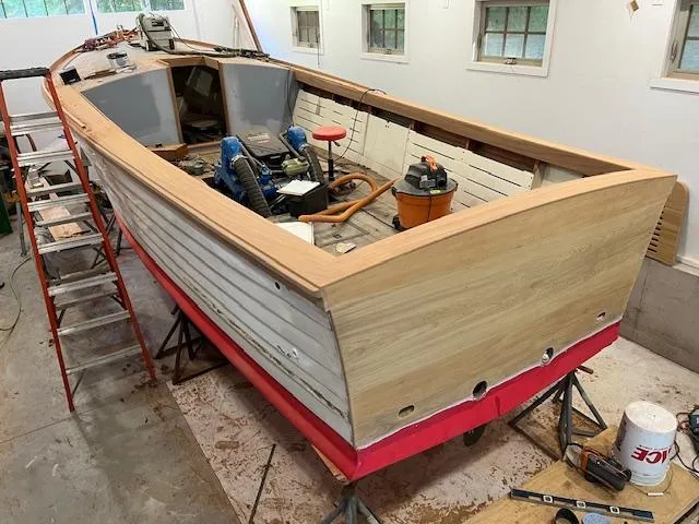 Slide: The Image of 2024 MacKenzie Cuttyhunk boat under restoration in a workshop setting. - 41