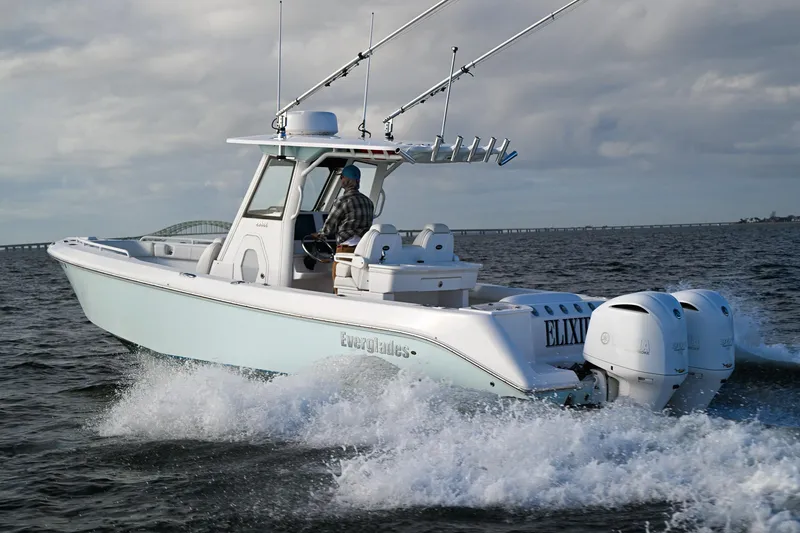 Slide: The Image of 2019 Everglades 295 Center Console boat cruising on open water. - 14