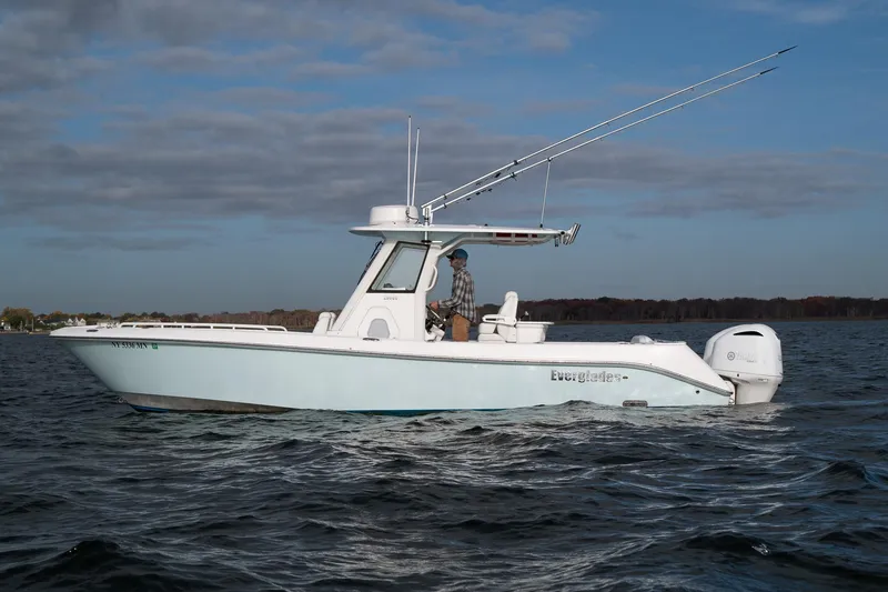 Slide: The Image of 2019 Everglades 295 Center Console boat on open water, side view. - 19