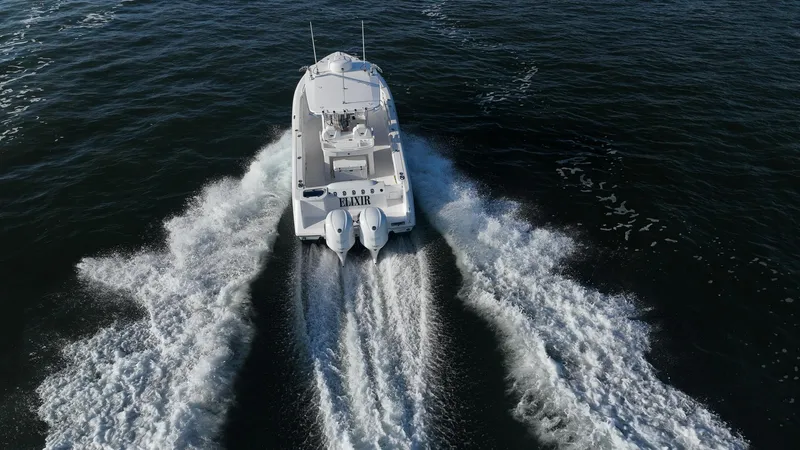 Slide: The Image of 2019 Everglades 295 Center Console boat cruising on open water. - 2