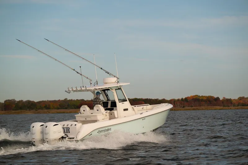 Slide: The Image of 2019 Everglades 295 Center Console boat cruising on open water. - 20