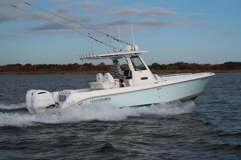 Slide: The Image of 2019 Everglades 295 Center Console boat cruising on open water. - 22