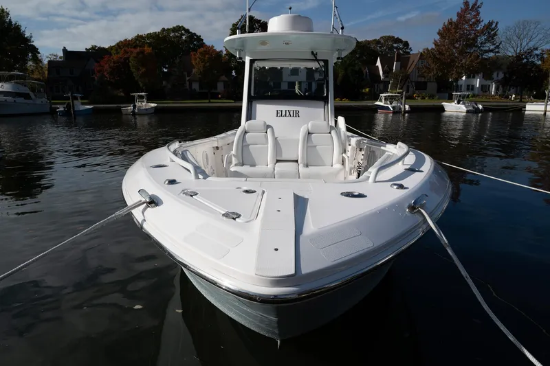 Slide: The Image of 2019 Everglades 295 Center Console boat docked on calm water. - 24