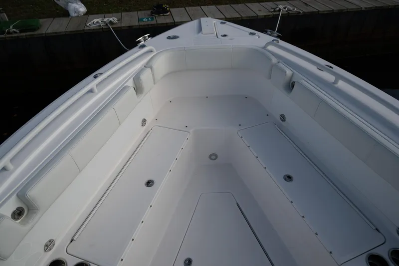 Slide: The Image of 2019 Everglades 295 Center Console boat interior, spacious deck with storage compartments. - 26