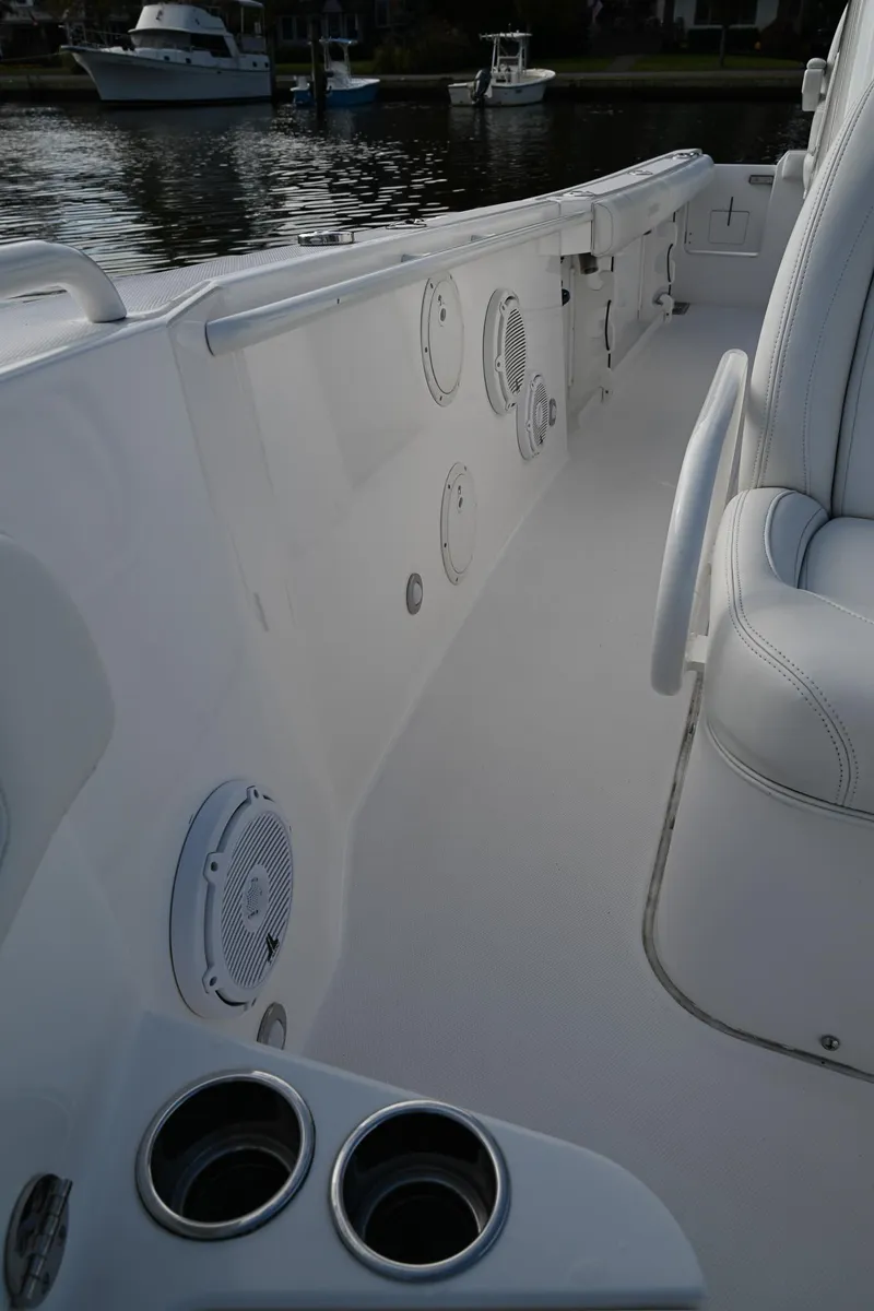 Slide: The Image of 2019 Everglades 295 Center Console boat interior with cup holders and seating. - 27