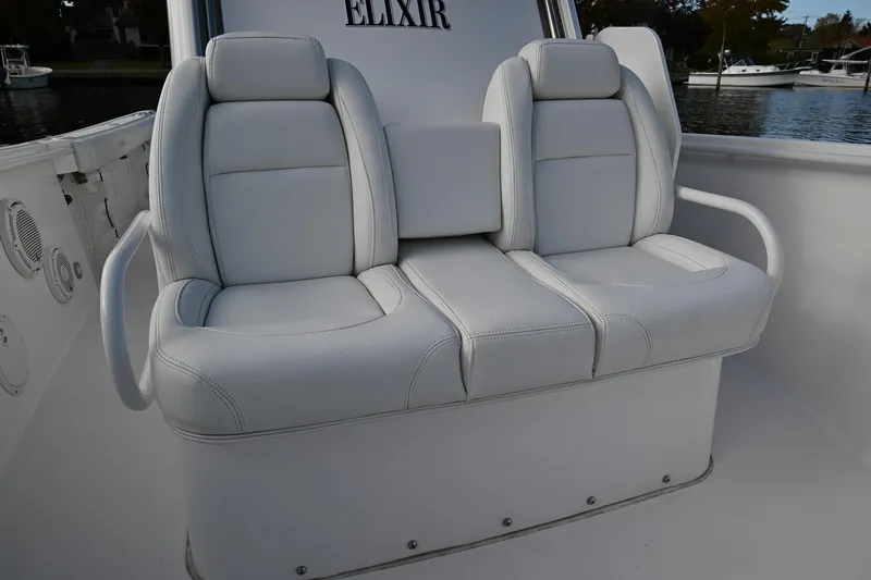 Slide: The Image of 2019 Everglades 295 Center Console boat with white cushioned seating. - 28