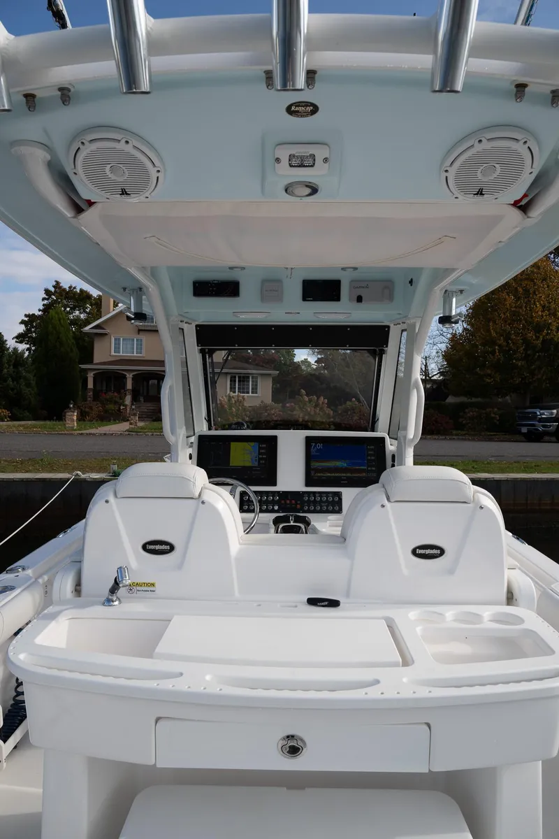 Slide: The Image of 2019 Everglades 295 Center Console boat interior with dual seats and navigation equipment. - 29