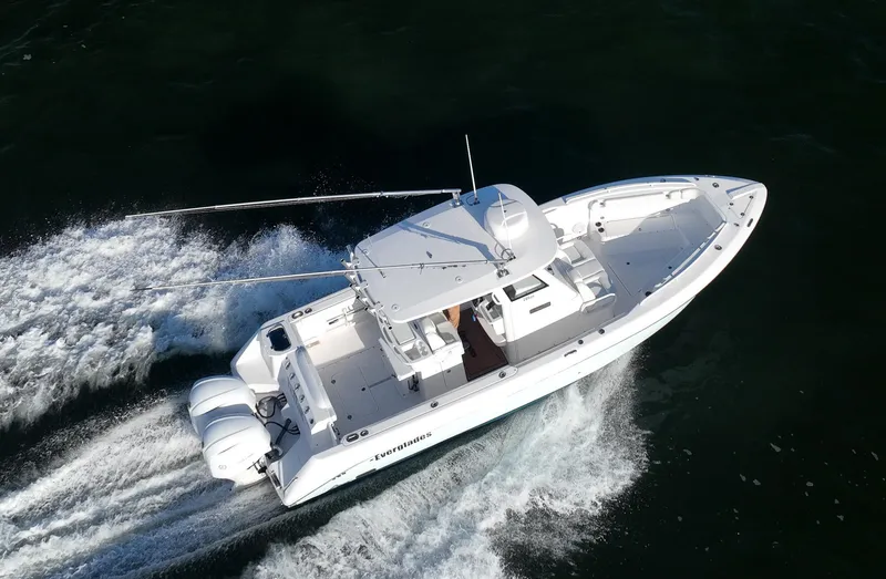 Slide: The Image of 2019 Everglades 295 Center Console boat cruising on water. - 3