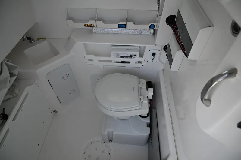 Slide: The Image of 2019 Everglades 295 Center Console boat interior with marine toilet and storage compartments. - 37